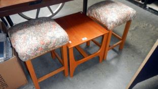 2 upholstered stools and 1 small table