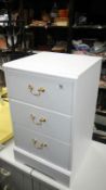 A white bed side 3 drawer chest of drawers