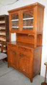 A late Victorian sideboard with glaze top cabinet