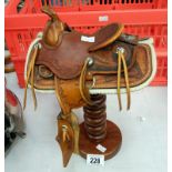 A miniature ornamental saddle on stand