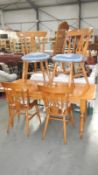 A pine dining table with 4 chairs