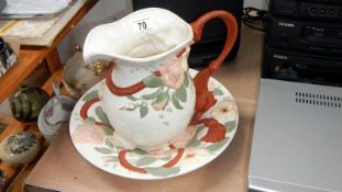 A jug and bowl set with raised floral decoration