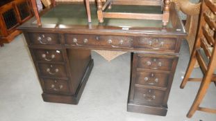 A small twin pedestal desk with leather top