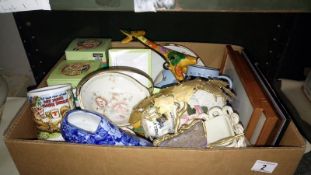 A box of miscellaneous items including cups & pictures