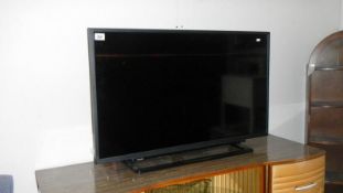 A Toshiba flat screen TV with remote control and instruction book