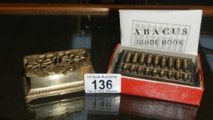 A brass stamp box & miniature brass abacus