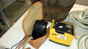 A Kodak bakelite127 camera in case and a Kodak Brownie Model 1 camera in box