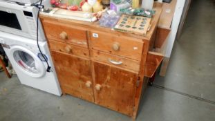 A pine cupboard with drawers