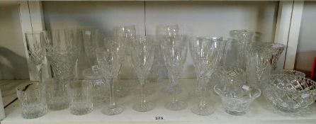 An assortment of crystal & other glassware including wine glasses & vases etc.