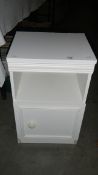 A white bed side cabinet