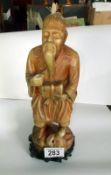 An Oriental figure of a man on small plinth a/f