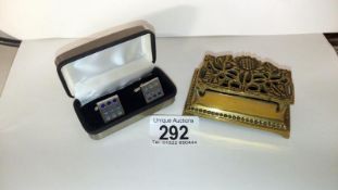 A brass inkstand and a pair of cufflinks