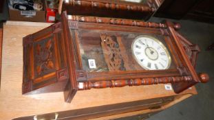 A wall clock with carved decoration