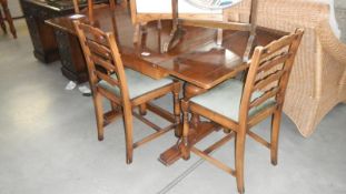 A draw leaf dining table with 4 chairs