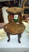 A small carved wooden table and one other