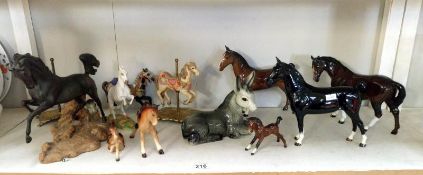 A quantity of horse ornaments including fairground horses etc.