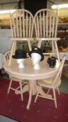 A circular painted dining table and 4 chairs