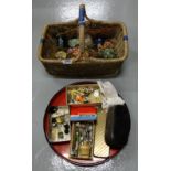 Basket of coloured glass paper weights and a tray of sewing materials – scissors, clothes buttons