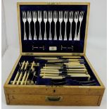 Canteen of Cutlery, in oak case, with a hinged hid and drawer, labelled “Hopkins & Hopkins, Dublin”,