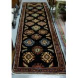 Black ground Iranian Runner, with bespoked all over designs 330cm by 0.90cm