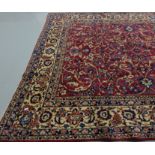 Large late 19thC Persian Wool Floor Rug, red ground with continual cream and navy patterns