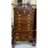 Mahogany Tallboy Chest of drawers, a swan neck top over 13 short and long drawers, on ball and