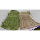 Two pairs of “Aran Crafts” woollen cable knit throws with matching cushion covers – 1 green, 1 brown
