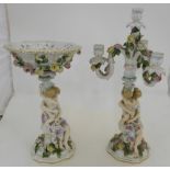 Two German Porcelain Table Centrepieces – 1 Fruit Bowl and 1 Candelabra, both supported by a lady