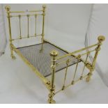 Miniature Victorian style brass bedstead, with turned end posts and metal base, castors, 24”l x 14”