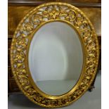 Carved Gilt Wood Framed Wall Mirror, oval shaped, with fretwork and mirrored borders, 42”h x 28”w