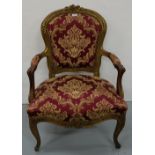 Carved wood framed Armchair, painted gold, the oval top over padded arms and sabre feet, red and