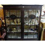 Early 20thC Mahogany Display Cabinet, the two glazed doors embossed with carved oval panels,