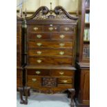 Mahogany Tallboy Chest of drawers, a swan neck top over 13 short and long drawers, on ball and