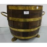 Round oak fuel barrel, brass banded with brass handles and 3 hair paw feet, 15”dia x 16”h