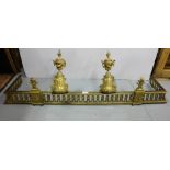 Pair of French Brass Urn Shaped Fire Dogs (12”h) and a similar pierced brass fire fender, 46”w (2)