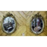 Matching Pair of Victorian Gilded Wall Mirrors, oval shaped bevelled edges and decorated in relief