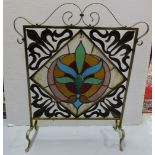 Brass framed firescreen with leaded glass insert and a copper art deco fire fender, 45” interior (