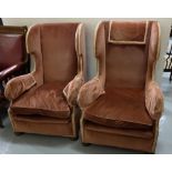 Matching Pair of High Wingback Armchairs, covered with pink velour fabric, button feet