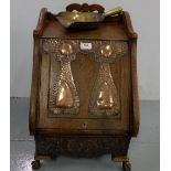 Art Deco Oak Fuel Box, with beaten copper panels mounted on the lid and raised base, on ball and