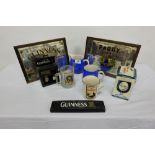 Group of Guinness etc items – 2 water jugs, paper weight, 2 modern mirrors, mugs etc