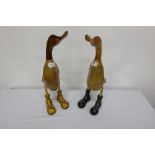 2 carved wooden ducks, wearing colourful (red, green) porcelain boots 19”h