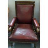 Edwardian Oak Framed Library Armchair, red leatherette seat and back, on turned front feet, castors