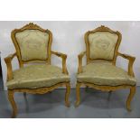 Matching Pair of Carved Wood Framed Armchairs, the fruit embossed and shaped tops over padded