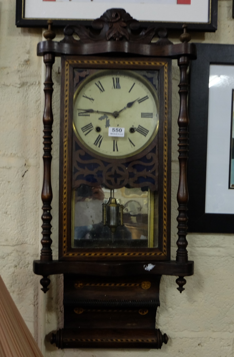8-Day Wall Clock in a rectangular shaped frame, with mirror back, inlaid with multiple woods,