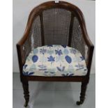 Regency Mahogany Library Chair, on turned front feet, brass cup castors, with bergere sides (bergere