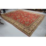 Old red ground Persian Tabriz carpet of a traditional all over floral design, 2.95mx3.65m