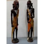 Pair of African carved Figures of Man & Woman in traditional costume, each 4ft high