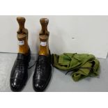 Matching of wooden shoe lasts in pair of black leather shoes