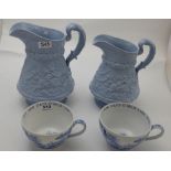 Pair of Spode breakfast cups & two graduating large blue Wedgwood water jugs (4)