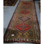 Large Persian Heriz runner with a unique medallion design 3.24m x 1.11m